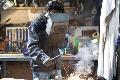 Young welder technician working in workshop