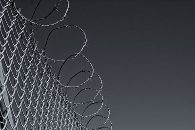 Close-up of barbed wire against clear sky