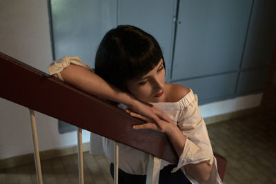 Young woman leaning on railing