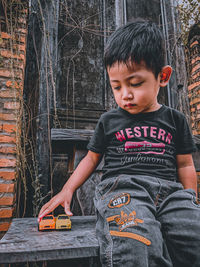 Portrait of boy sitting on chair