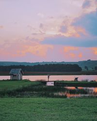 Scenic view of field against sky during sunset