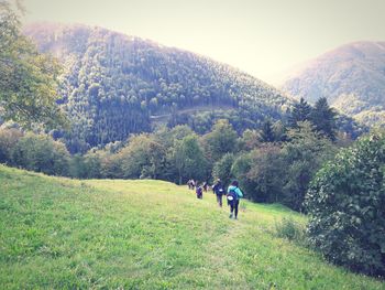 People on field against mountain