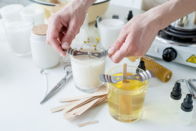 Cropped hands of man preparing food on table