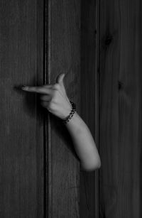 Close-up of hand obscene gesture on door