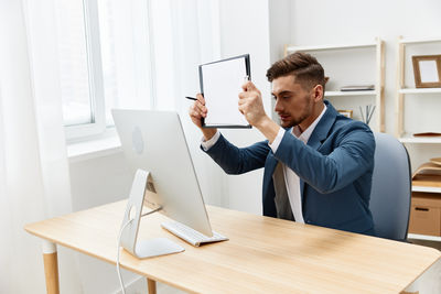 Midsection of businessman working at desk in office