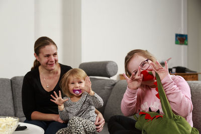 Mother with daughters on sofa