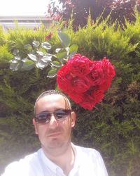 Portrait of man with red roses