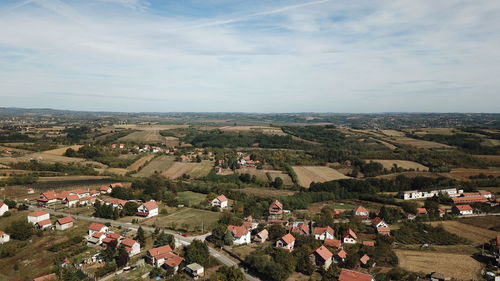 High angle view of houses on field against sky