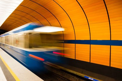 Blurred motion of train at railroad station