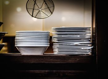 Stack of plates and bowls on table