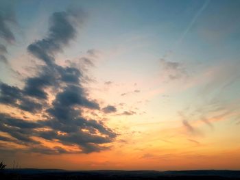 Low angle view of dramatic sky over sea during sunset