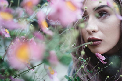 Close-up portrait of woman with pink flowers