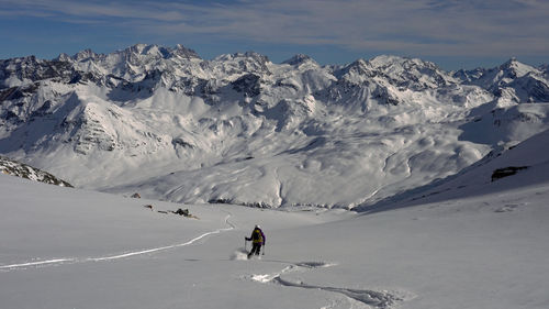 People skiing on snowcapped mountain