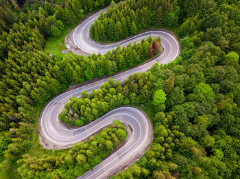 High angle view of vehicles on road amidst trees