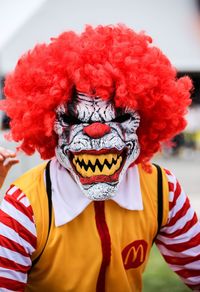 Close-up portrait of a boy with red umbrella