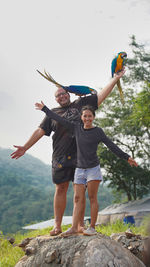 Full length of woman jumping on rock