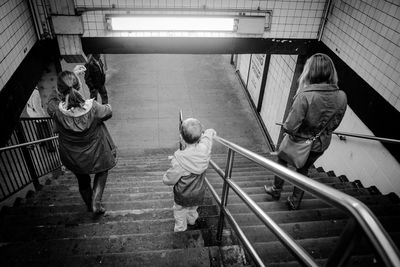 Full length of woman standing on staircase