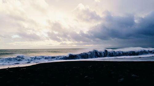 Scenic view of sea against cloudy sky
