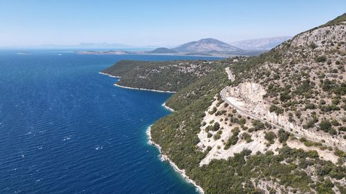 High angle view of sea and mountains against sky