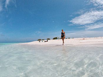 Full length of man on beach against sky