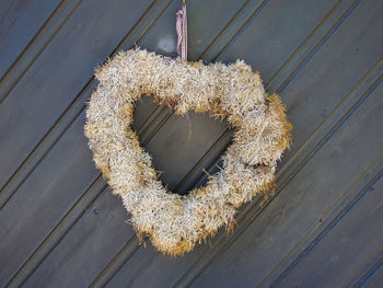 Close-up of heart shape decoration hanging against wall