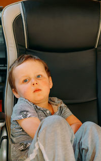 Portrait of boy sitting on chair