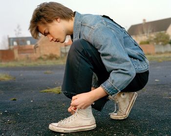 Side view of boy standing outdoors