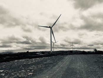 Windmill on field against sky