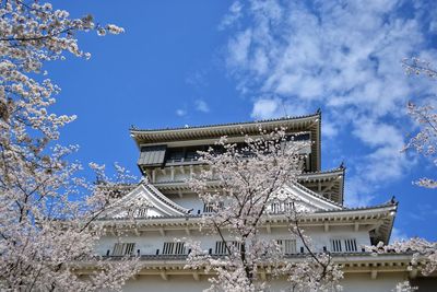 Low angle view of temple and building against sky