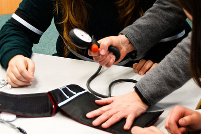 High angle view of people examining blood pressure gauge