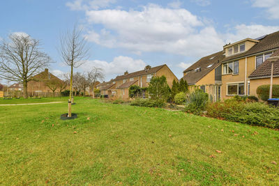 Houses on field against sky