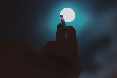 Close-up of hand holding illuminated light