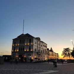 Buildings in city at sunset