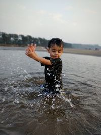 Boy standing in sea