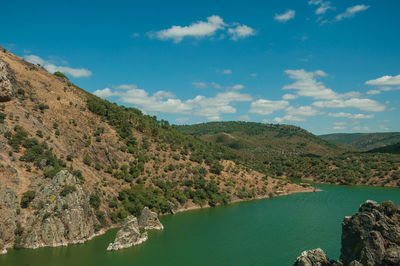 Scenic view of lake and mountains against sky