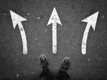 Low section of man standing on road