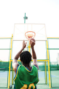 Black man playing basketball game