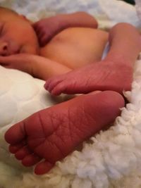Close-up of baby lying on hand