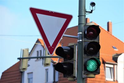 Road sign against sky in city