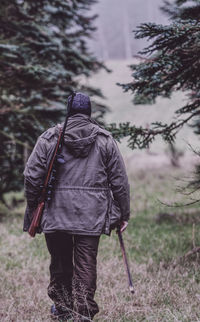 Rear view of person walking on land