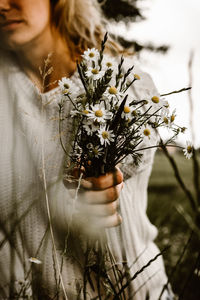 Close-up of woman holding flower bouquet