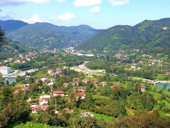 High angle view of townscape and mountains against sky