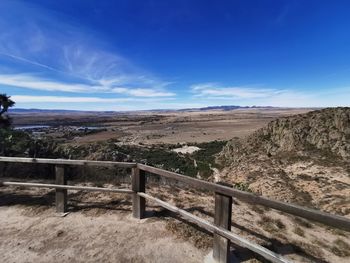 Scenic view of landscape against blue sky