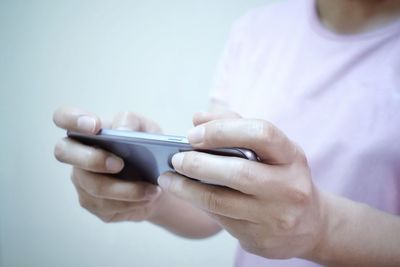 Midsection of man using mobile phone
