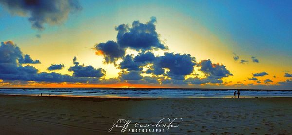 Scenic view of beach against sky during sunset