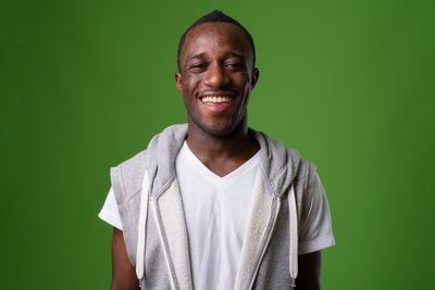 Portrait of a smiling man against green background