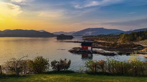 Scenic view of lake against sky during sunset