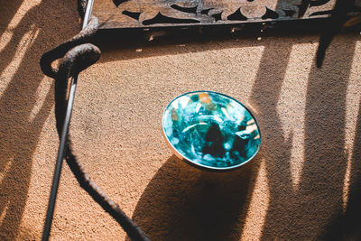High angle view of blue glass on wall