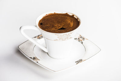 High angle view of coffee cup over white background