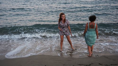 Women standing on beach